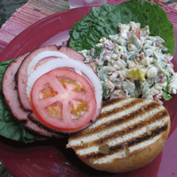 Smoked bologna sandwich with fixins and fancy potato salad